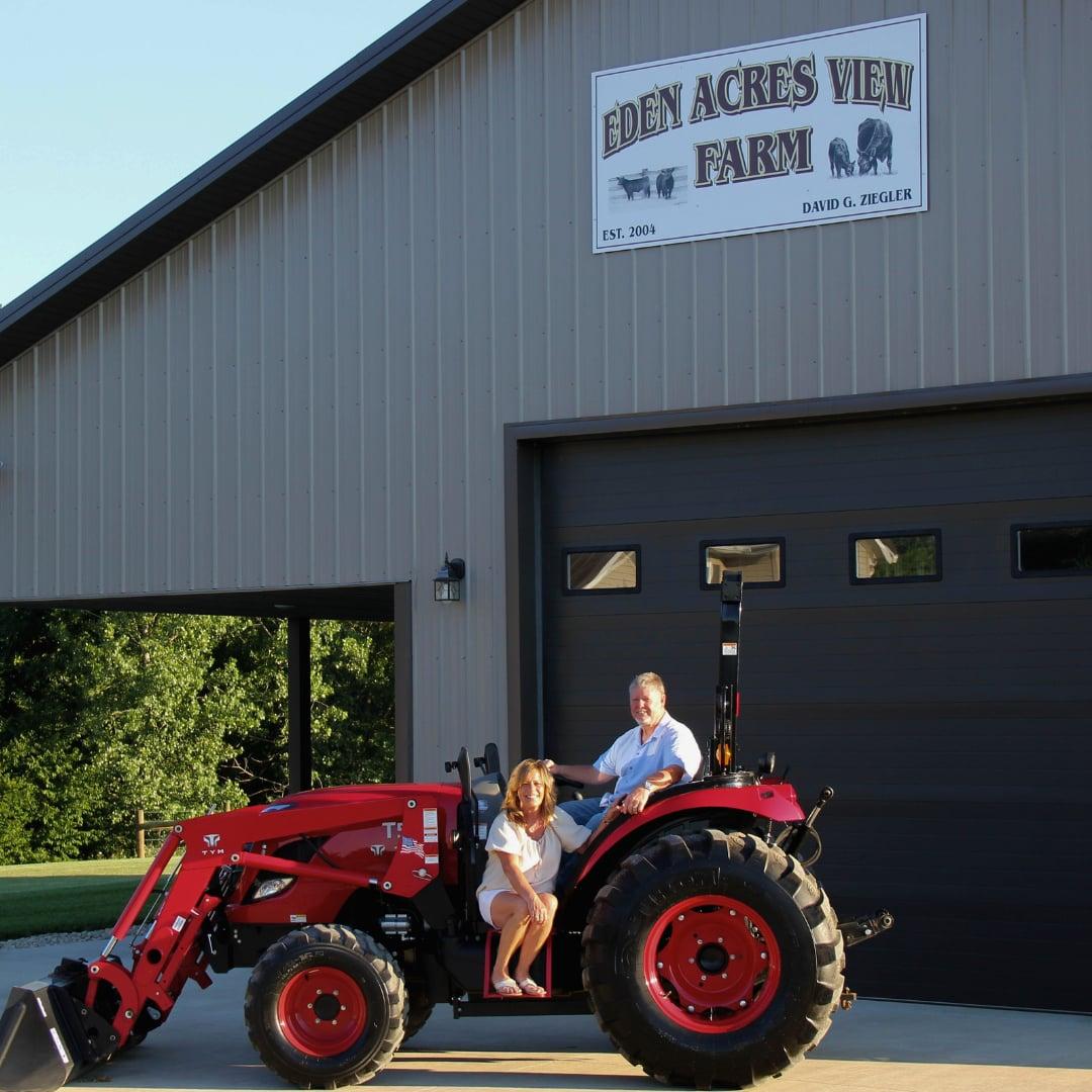 David and Judy on the tractor at Eden Acres View Farm